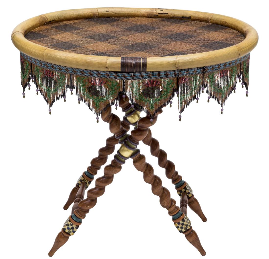 MACKENZIE-CHILDS RATTAN BEADED BARLEY TRAY TABLE: Mackenzie-Childs tray top table on folding base, the oval tray having bent bamboo frame, central woven Ajiro rattan check pattern, all above colored beaded fringe, stamped under tray, resting on a fol
