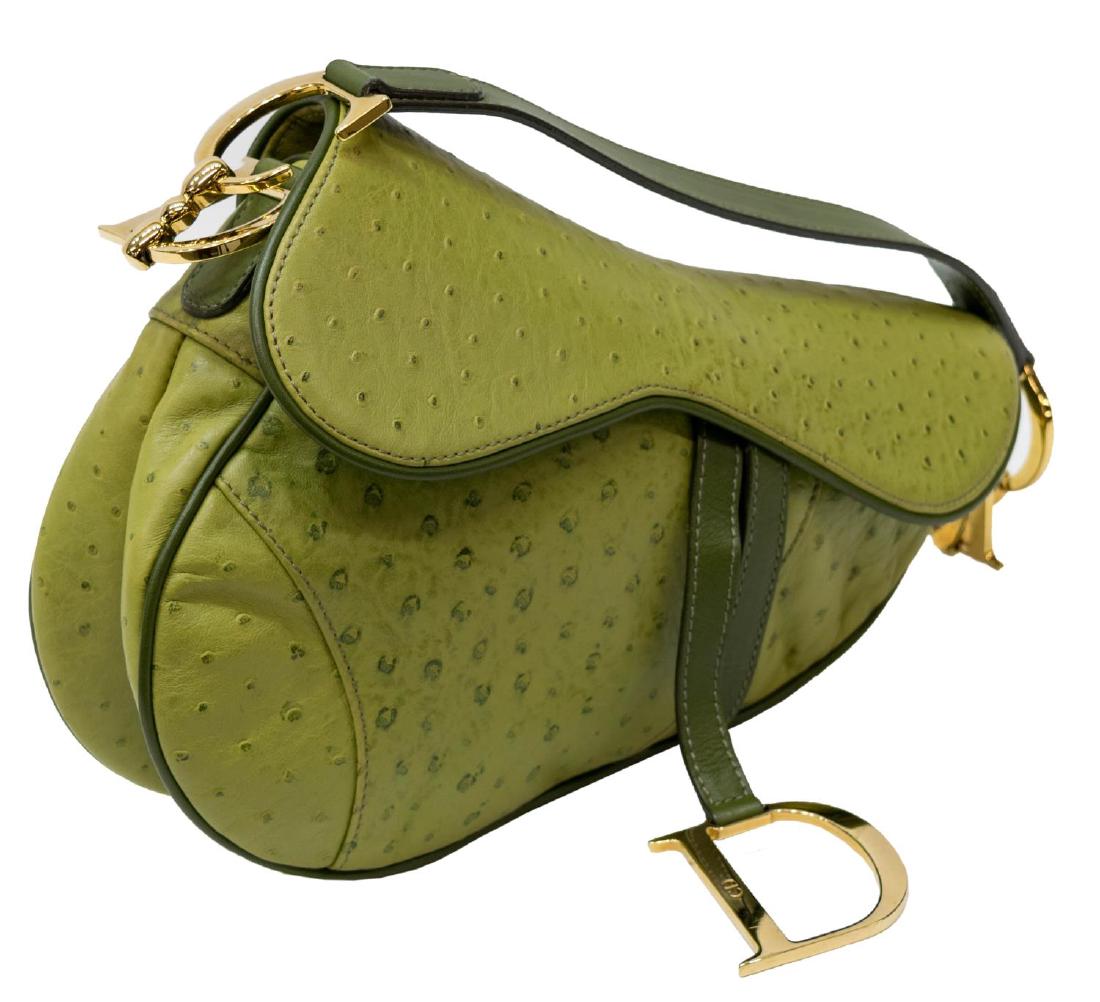 CHRISTIAN DIOR 'SADDLE' GREEN OSTRICH LEATHER BAG: Christian Dior "Saddle" bag in green ostrich leather, having green leather trim, gold tone hardware, the single strap over a shaped flap top, interior with with single zipper pocket, exterior snap poc