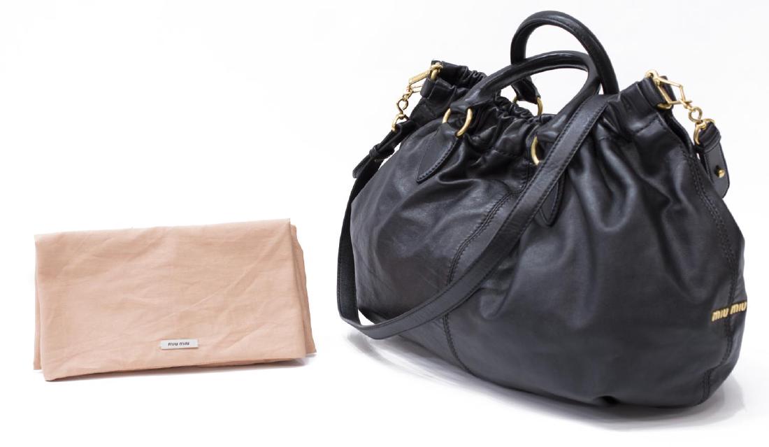 MIU MIU 'VITELLO LUX GATHER' BLACK LEATHER HANDBAG: Miu Miu "Vitello Lux Gather" cross body hand bag in black leather, having gold tone hardware, duel roll handles above the gathered top, opening to interior with single zipper pocket, retaining shoulde
