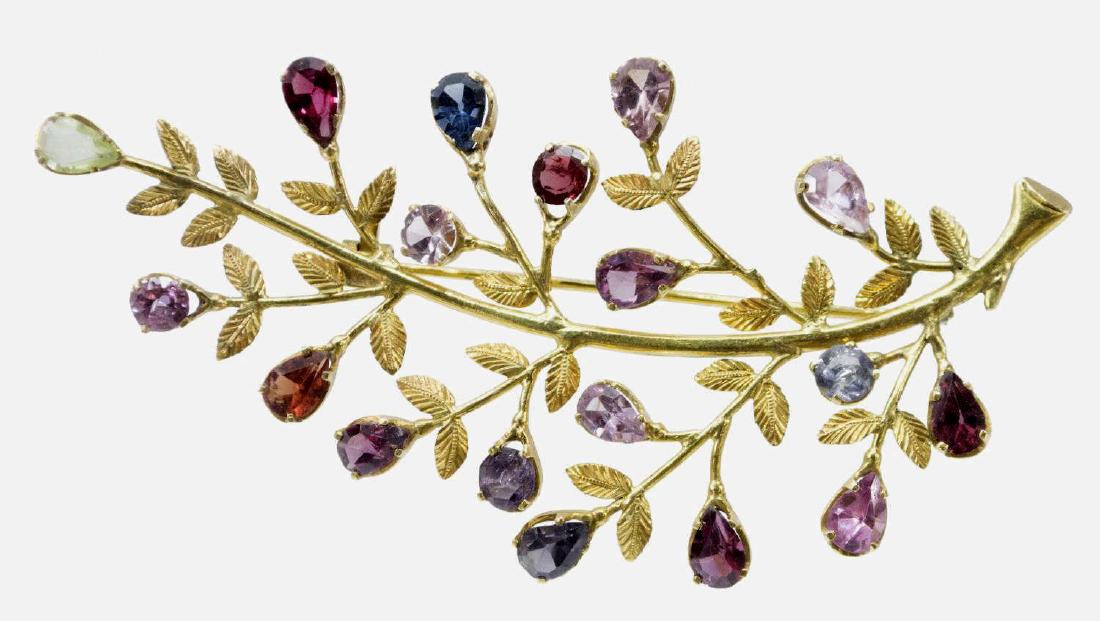 LADIES ESTATE 18KT GOLD & GEMSTONE FOLIATE BROOCH: Ladies estate 18kt gold and gemstone brooch, the foliate form mount set with (19) multi-colored spinel stones, pin back, unmarked, fracture to one branch, 3.25"l, 12.1 grams (inclusive of all material