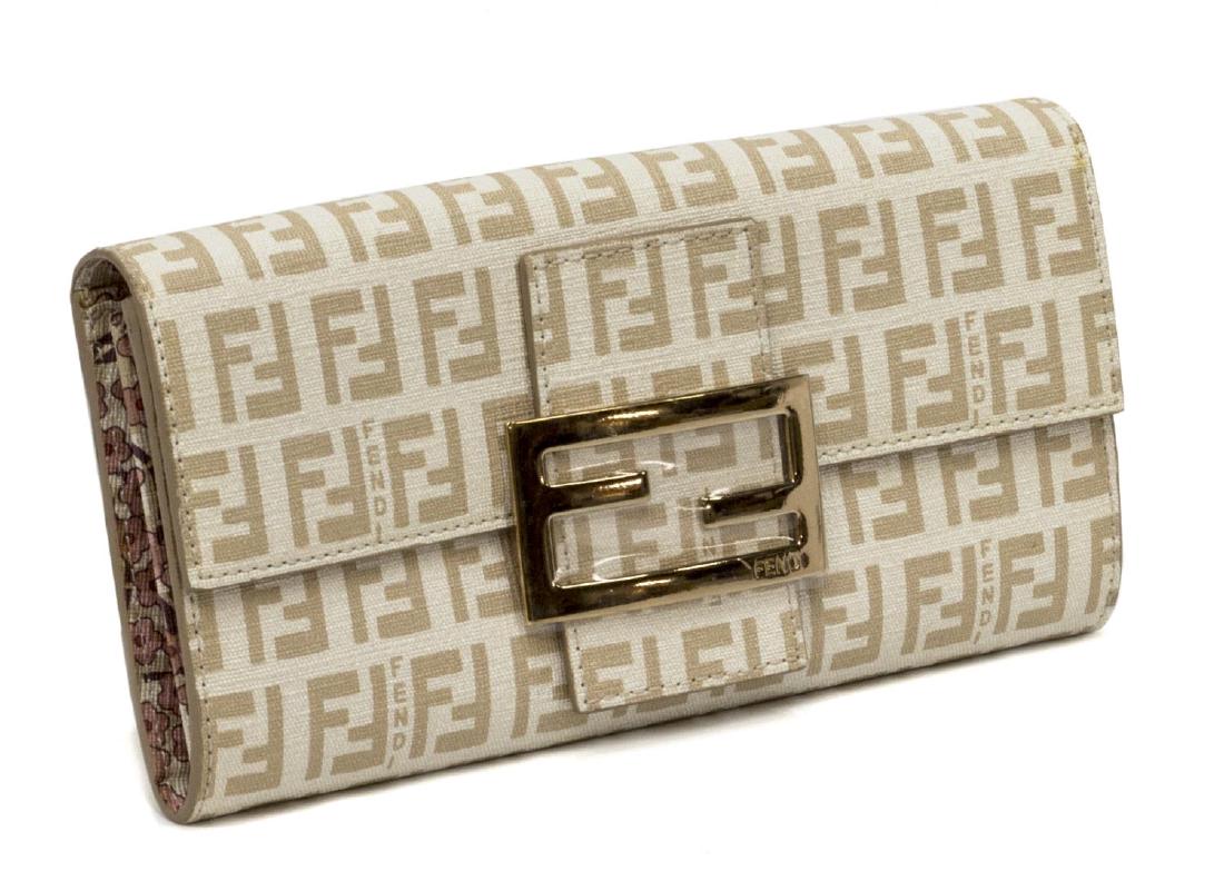 FENDI MONOGRAM COATED CANVAS CREAM WALLET: Fendi long wallet in cream and tan monogram coated canvas, having gold tone hardware, the logo buckle front opening to floral interior, central zip compartment, card slots, and cash slots, accompanied