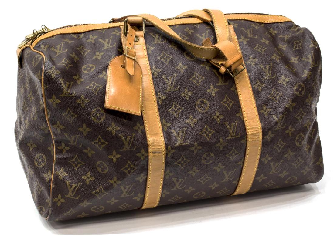 LOUIS VUITTON MONOGRAM CANVAS SAC SOUPLE 45: Louis Vuitton "Sac Souple 45" in monogram canvas, leather handles and accents, gold tone hardware, accompanied by leather luggage tag and handle buckle, creasing and some discoloration to leather, bag