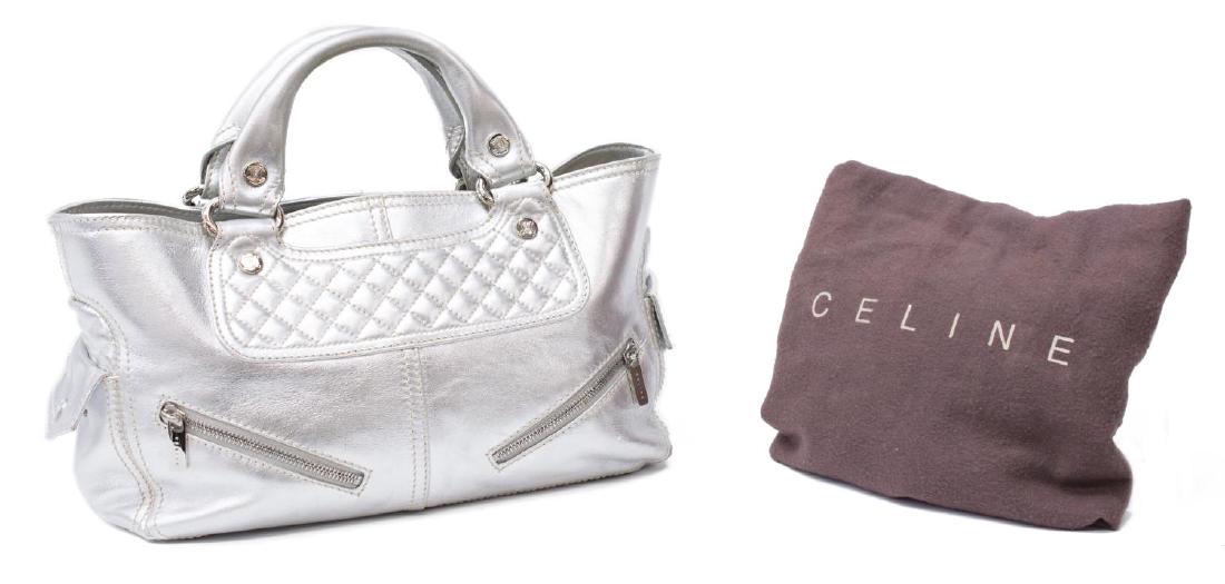 CELINE 'BOOGIE MM' SILVER LEATHER HAND BAG: Celine "Boogie MM' handbag in silver leather, having silver toned hardware, duel roll handles, flanked exterior side slots, opening to a tan fabric interior with a centered full length zipper pocket f