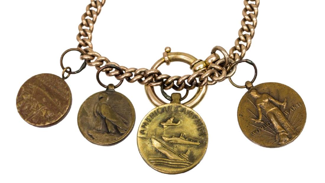 ESTATE 10KT GOLD & WWII MEDALLION COIN BRACELET: Estate 10kt yellow bracelet or watch fob, the chain issuing (4) WWII medallion coins, (one) European African Eastern Campaign, (one) Asian Pacific Campaign, (1) American Campaign, (one) United States 