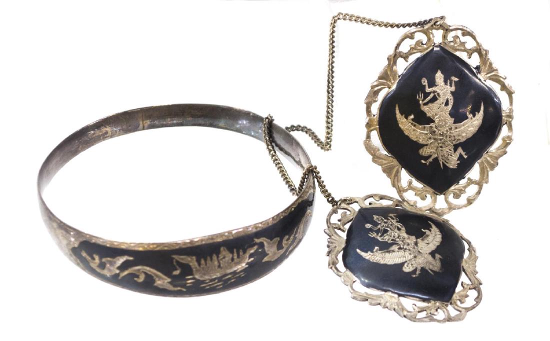 (2) LADIES ESTATE SIAM STERLING BRACLET & CLASP: (lot of 2) Ladies estate Siam sterling silver jewelry, comprising: (1) pierced sweater clasp, with toned figural reserves, joined by chain, 10"l; (1) bangle bracelet, etched boat design, marked inside