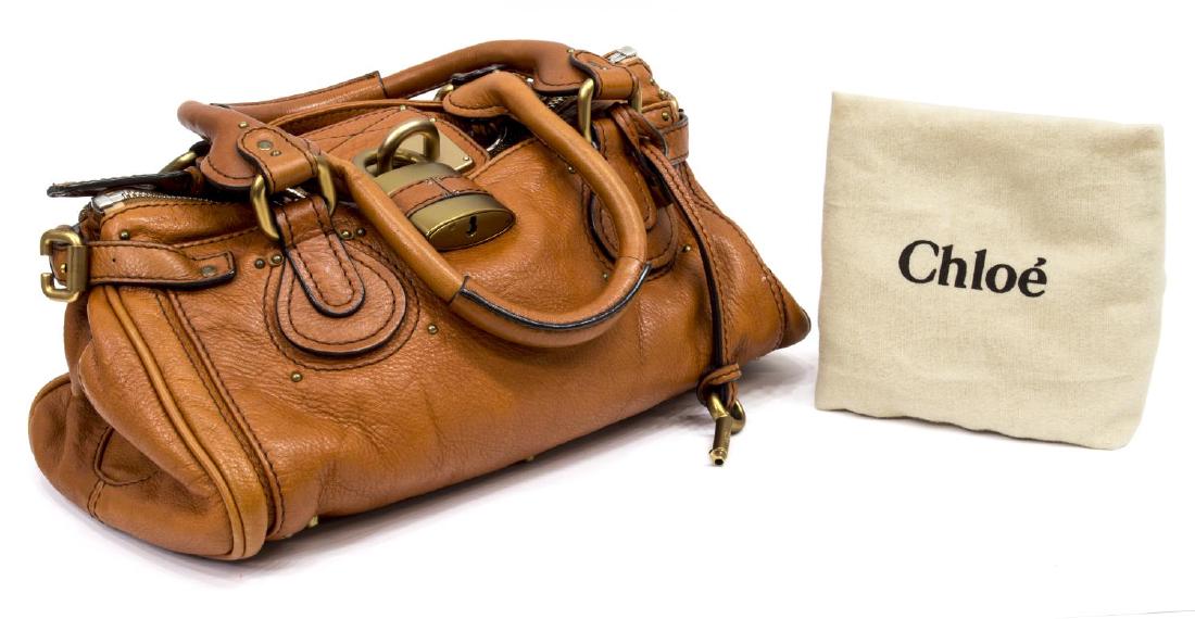 CHLOE 'PADDINGTON MM' COGNAC LEATHER SHOUDLER BAG: Chloe "Paddington" in cognac leather with gold tone hardware, two exterior slot pockets, top unzips to dark brown cloth lined interior featuring slot and zipped pockets, on small metal feet, with sign