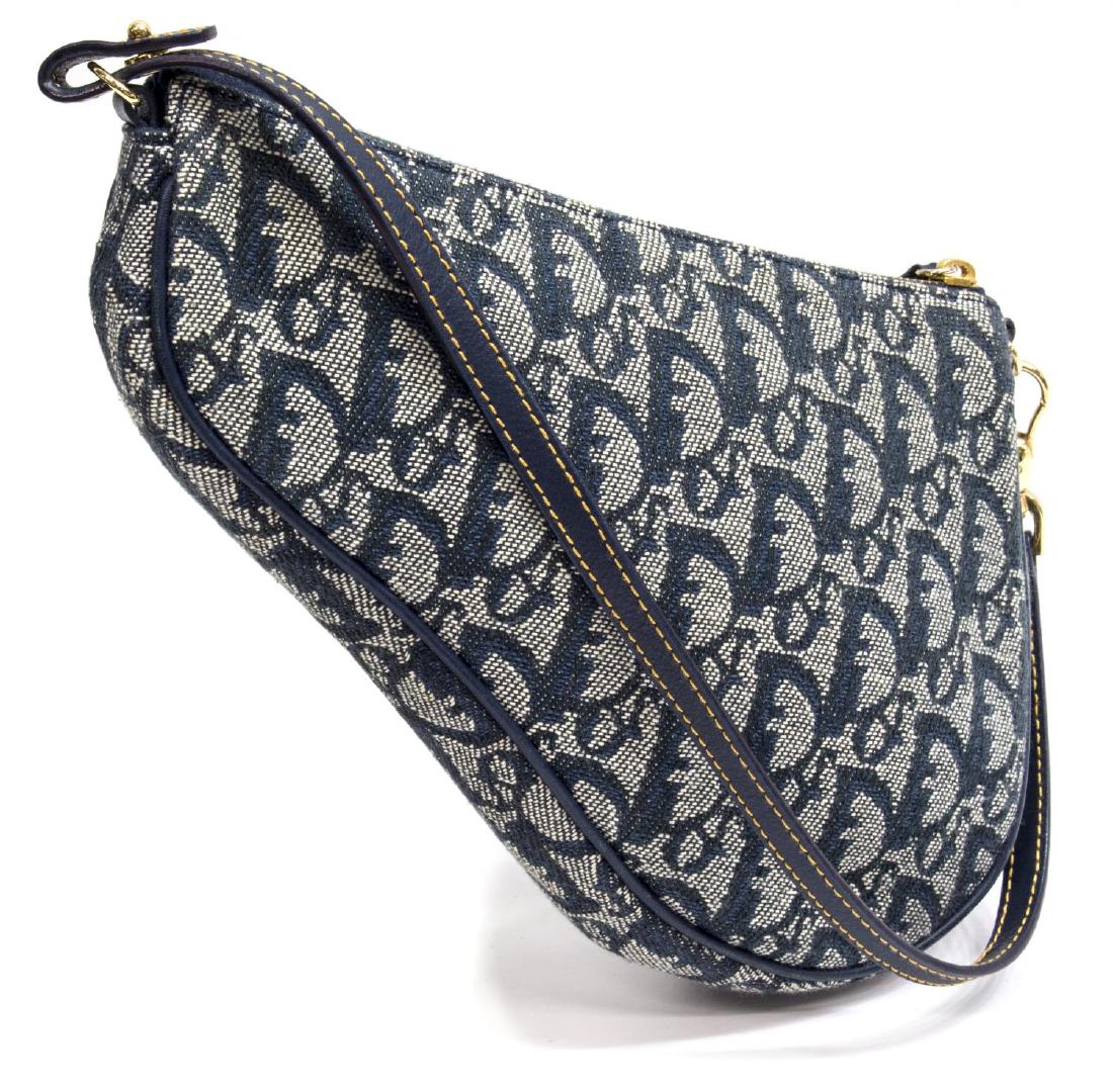 CHRISTIAN DIOR 'SADDLE' MONOGRAM ACCESSORY POUCH: Christian Dior 'Saddle' accessory pouch in navy blue monogram, having gold tone hardware, with short strap over zip top, opening to lined interior, bag: approx 6.5"h, 9.5"w, 1.25"d, .25lb