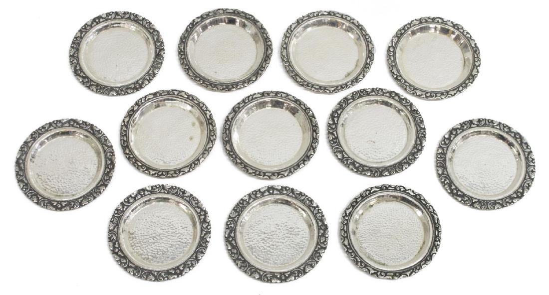 (14) INDONESIAN .800 REPOUSSE "YOGYA" COASTERS: (lot of 14) Southeast Asian Indonesian .800 silver repousse "Yogya" coasters, each with a pierced foliate rim around the hammered central reserve, 3.75" diam., 19.43 ozt Start Price: $150.00