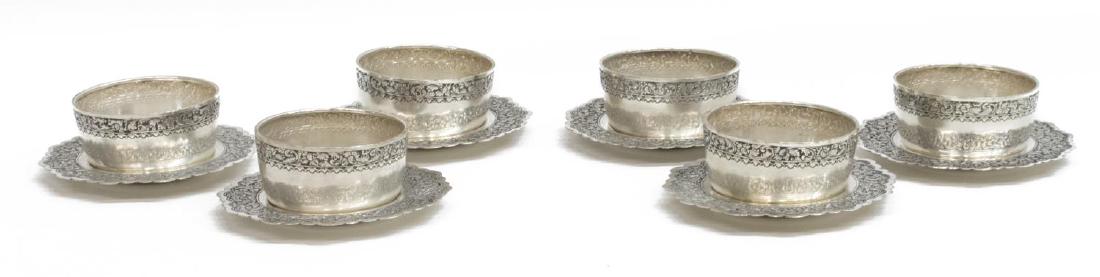 12) INDONESIAN .800 SILVER REPOUSSE CUPS & SAUCERS: (lot of 12) Southeast Asian Indonesian .800 silver drinkware, decorated with foliate bands, comprising: (6) handle-less cups, 1.5"h, 3.25" diam.; and (6) saucers, with scalloped rim, 5" diam.; 24.62oz