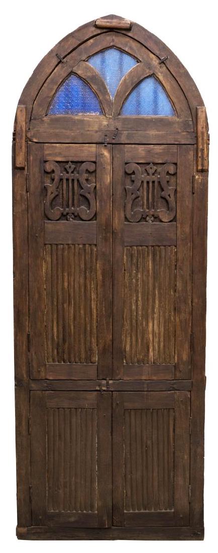 BRITISH COLONIAL STYLE TEAKWOOD CHURCH WINDOW: British Colonial style carved teakwood church window, the arched top set with blue stained glass panels, over lyre panels and two set of shutters, 90"h, 33"w, 4"d Start Price: $150.00