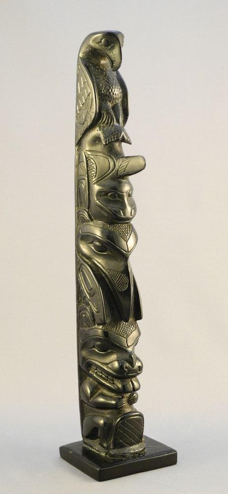 Early carved argillite pole, 11".: Early carved argillite pole, 11".
