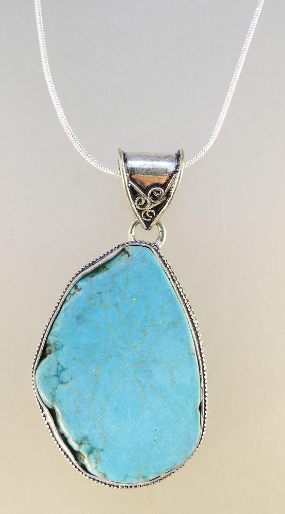 Silver mounted turquoise pendant on chain. (1 of 2)