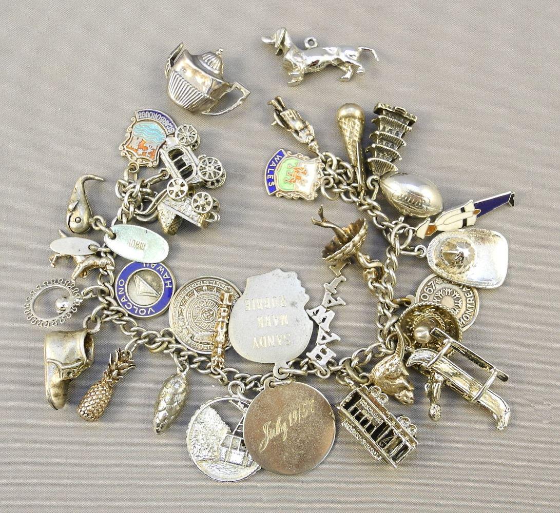 Sterling silver charm bracelet with various charms.: Sterling silver charm bracelet with various charms.