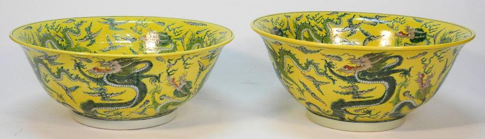 Pair of Chinese famille jaune porcelain "Dragon" blows,: Pair of Chinese famille jaune porcelain "Dragon" blows, Kangxi mark, 15 1/2" diameter.