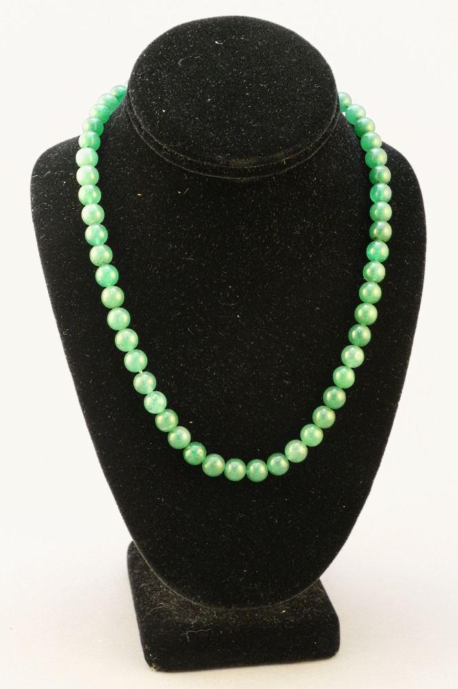 Strand of uniform Jadeite beads with 14K Gold clasp.: Strand of uniform Jadeite beads with 14K Gold clasp.