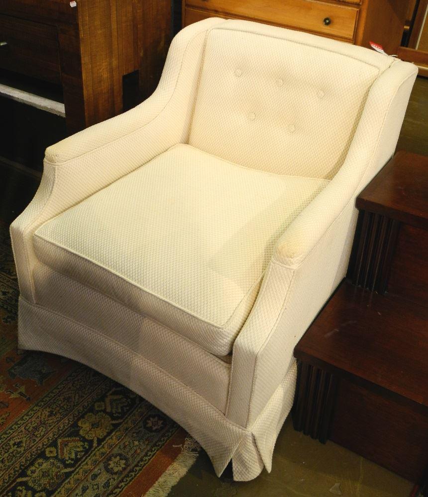 Pair of cream coloured sloped armchairs.: Pair of cream coloured sloped armchairs.