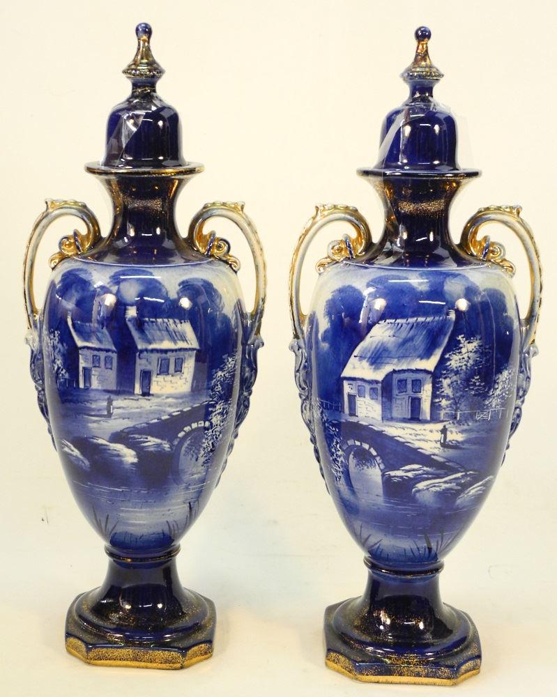 Pair of English Pottery Flow Blue Covered Urns, 19 1/4": Pair of English Pottery Flow Blue Covered Urns, 19 1/4" high, finials restored.