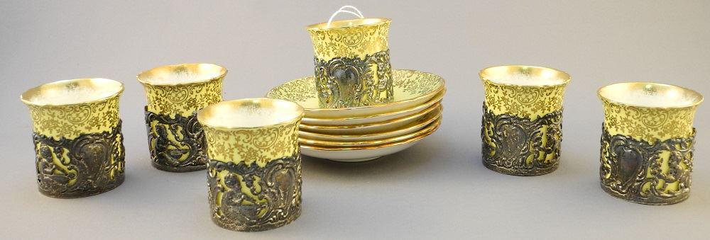 6 Demitasse Cups & Saucers in Hallmarked Silver Frames,: 6 Demitasse Cups & Saucers in Hallmarked Silver Frames, each 2 3/8" x 4 3/8". See condition report.
