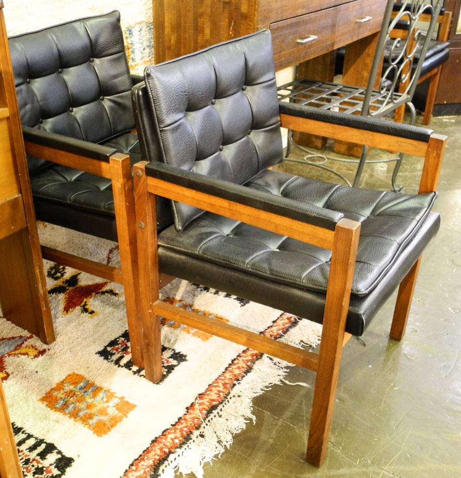 Three modern black leather & walnut office chairs.: Three modern black leather & walnut office chairs.
