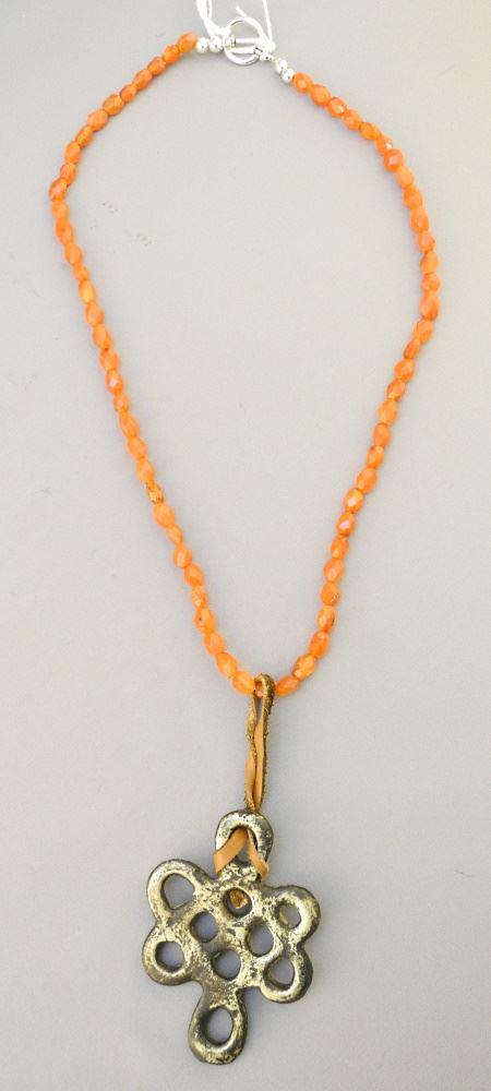 Faceted Carnelian Beaded Necklace with Tibetan Endless: Faceted Carnelian Beaded Necklace with Tibetan Endless Knot, 22" length.