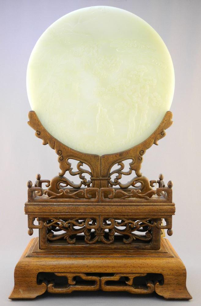 Jade "Landscape" Roundel (10 3/8" Diameter) supported upon elaborate Wood Base 20x12x6".: Jade "Landscape" Roundel (10 3/8" Diameter) supported upon elaborate Wood Base 20x12x6".