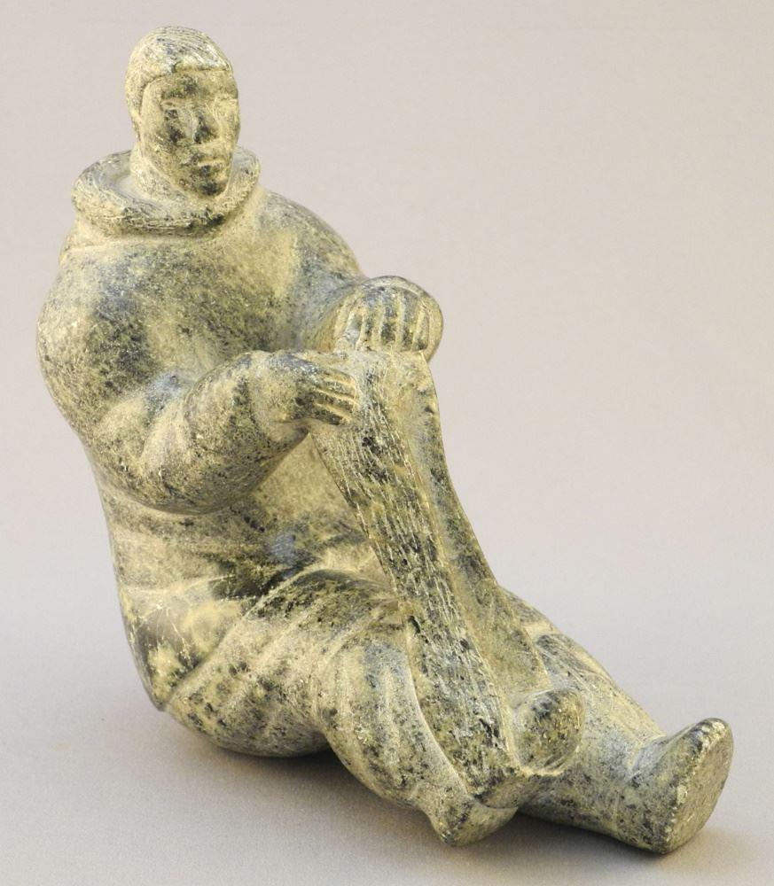 Inuit Hardstone Carving "Stretching Seal Skin", 5 1/2 High.: Inuit Hardstone Carving "Stretching Seal Skin", 5 1/2 High.