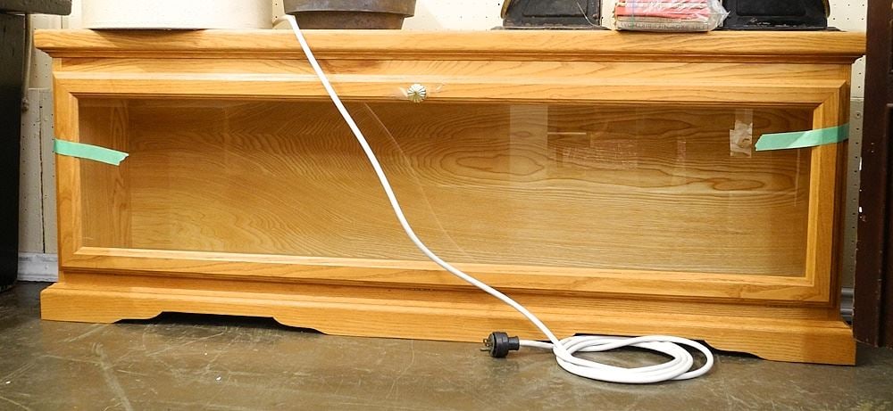 Ash Illuminated Collector's Cabinet, 54"W (latch noted).: Ash Illuminated Collector's Cabinet, 54"W (latch noted).