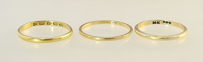 Three Gold Bands: 14K (Size 6, 1.23g ) / 18K (Size 6 1/2, .99g) / 22K (Size 6 1/2, 1.58g).: Three Gold Bands: 14K (Size 6, 1.23g ) / 18K (Size 6 1/2, .99g) / 22K (Size 6 1/2, 1.58g).