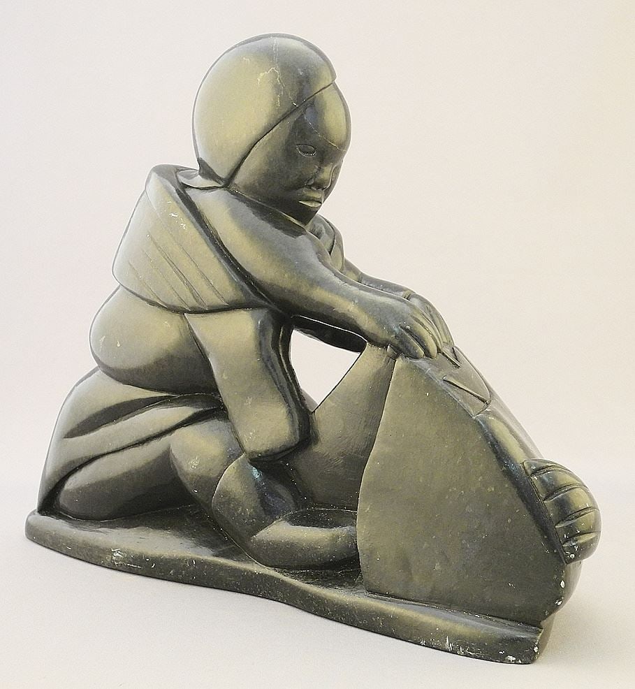 Inuit Sculpture signed Sampson Kingalik, 11" x 9" x 3 1/2", "Figure Skinning Seal".: Inuit Sculpture signed Sampson Kingalik, 11" x 9" x 3 1/2", "Figure Skinning Seal".