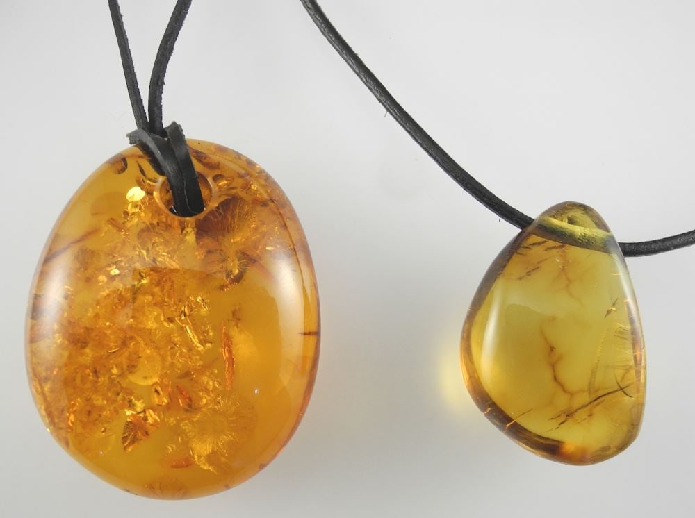 Two Amber Pendants on Leather Cords, 1 5/8 & 2"h.: Two Amber Pendants on Leather Cords, 1 5/8 & 2"h.