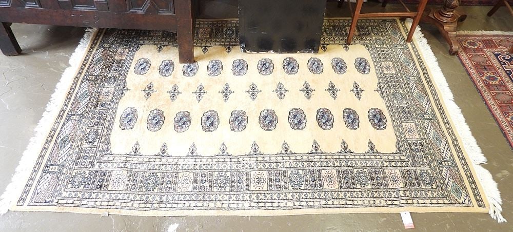 Gold Tone Bokhara Wool Carpet Approximately 4'9" x 7'3".: Gold Tone Bokhara Wool Carpet Approximately 4'9" x 7'3".