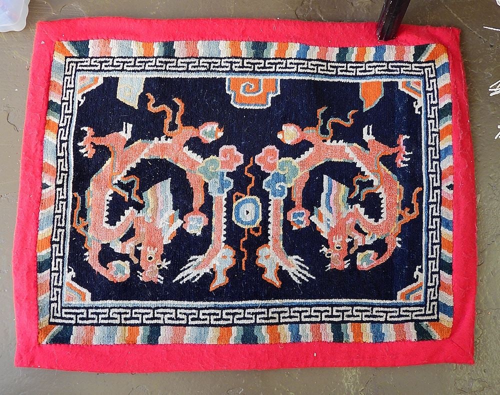 Tibetan Wool Mat with Red Border, 24 x 36".: Tibetan Wool Mat with Red Border, 24 x 36".