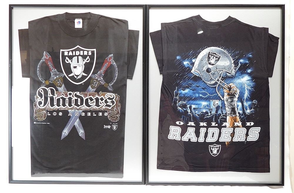 Pair of Framed Oakland & Los Angeles Raiders T-Shirts, 32 x 24". (1 of 3)