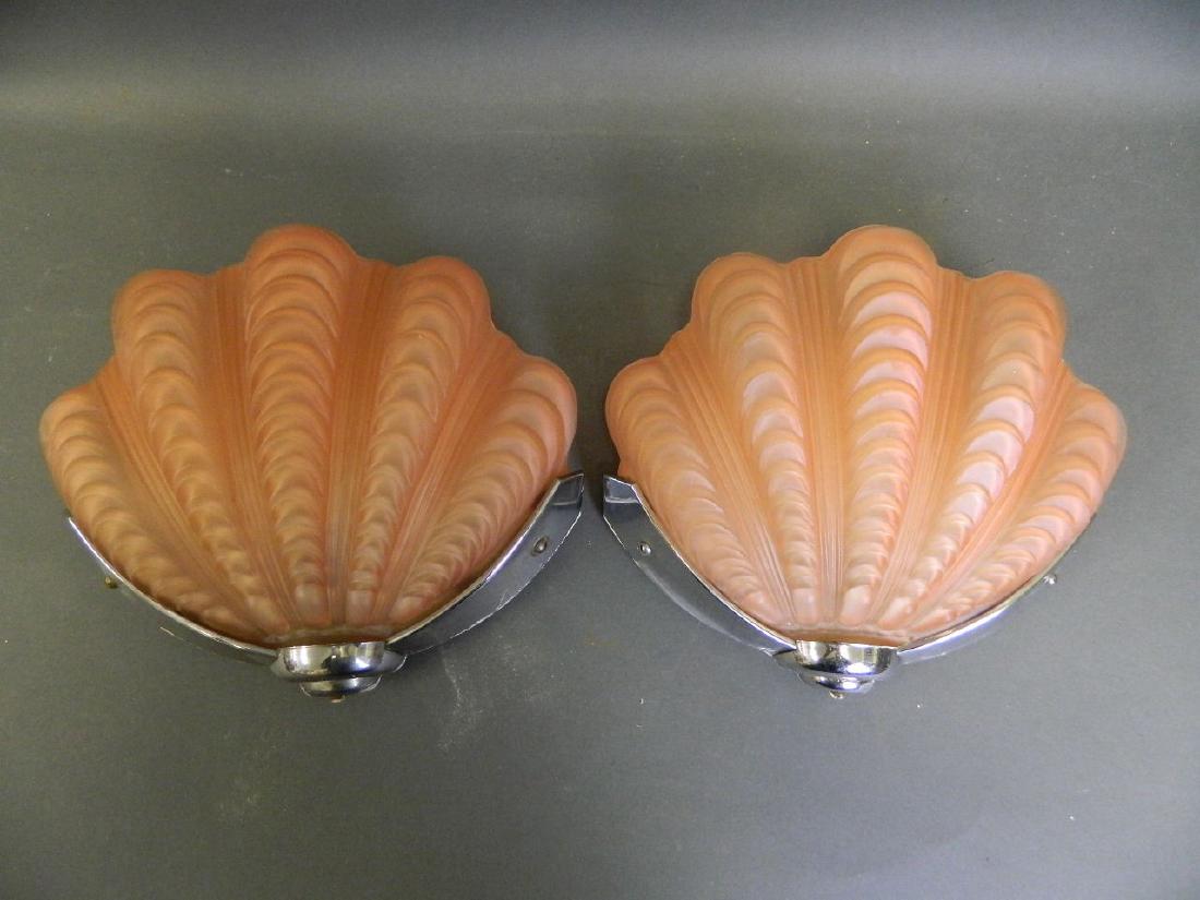 A pair of Art Deco period wall lights with coral: A pair of Art Deco period wall lights with coral coloured glass shades in the form of clams, 10" long
