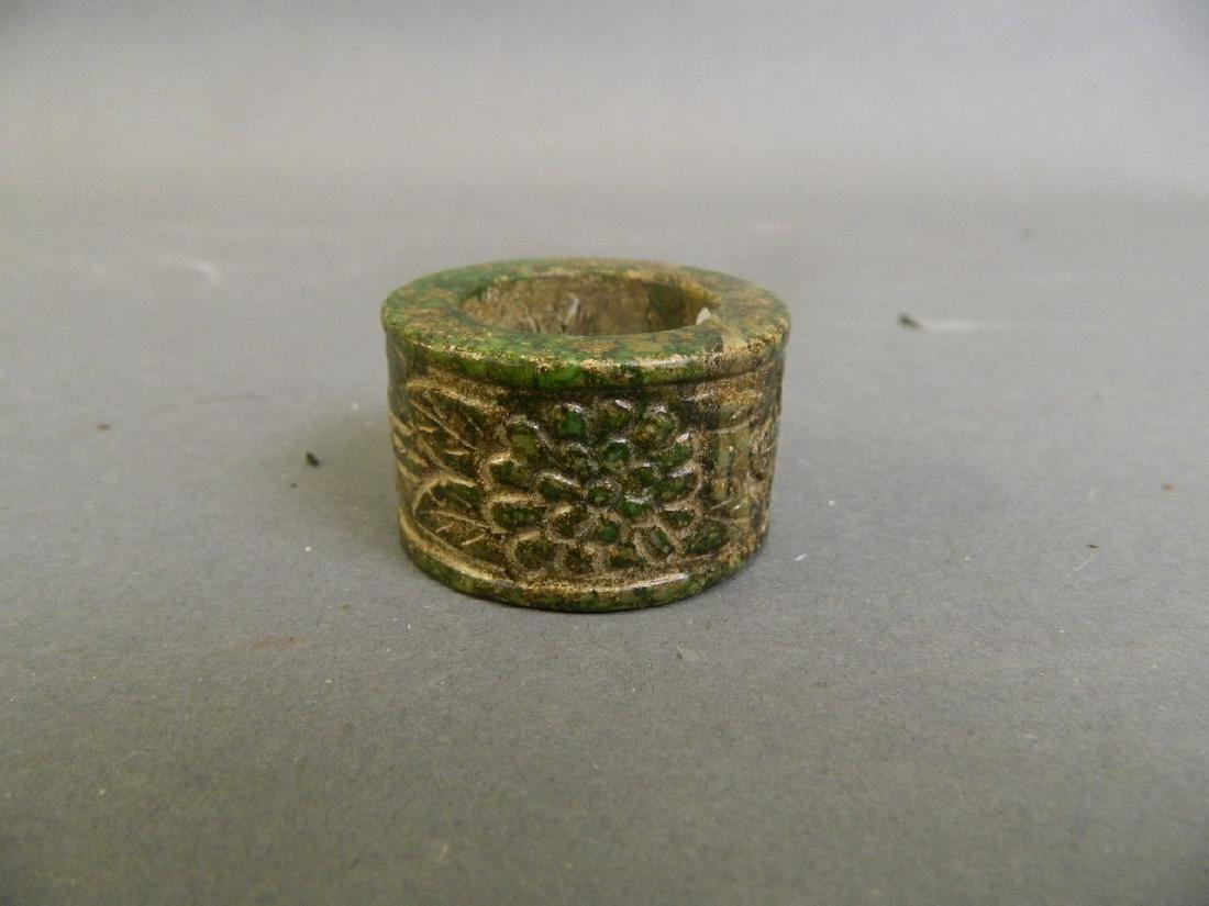 A Chinese hardstone archers ring with carved foliate (1 of 2)
