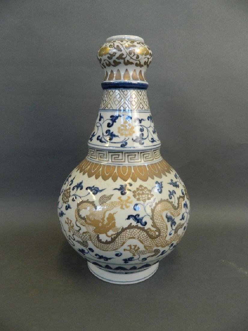A Chinese blue and white porcelain vase of unusual form: A Chinese blue and white porcelain vase of unusual form with painted gilt dragon and lotus flower decoration, 6 character mark to base, 13" high