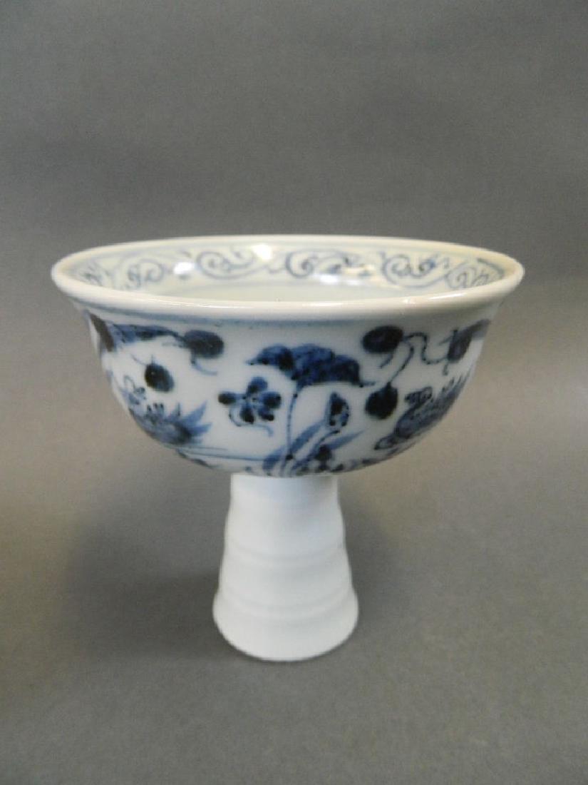 A Chinese blue and white porcelain stem cup decorated: A Chinese blue and white porcelain stem cup decorated with waterfowl and plants, 3½" high