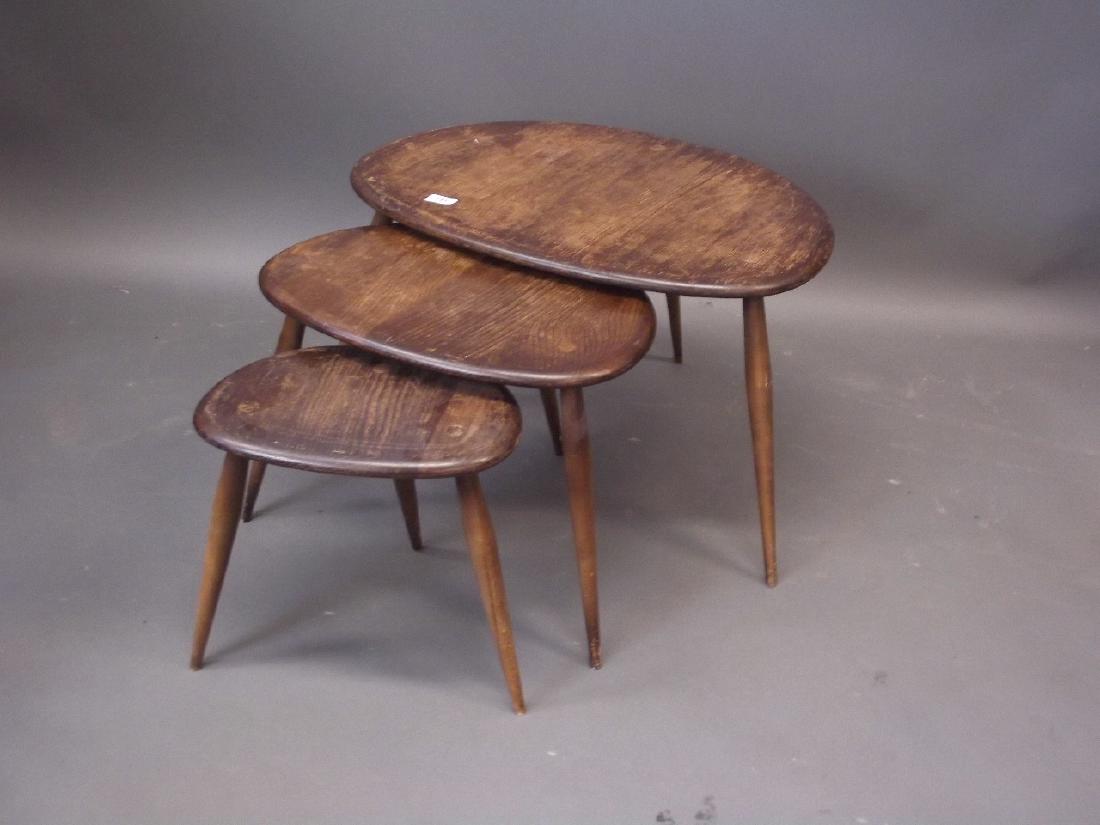 A nest of three Ercol stained ash pebble occasional: A nest of three Ercol stained ash pebble occasional tables, largest 26" x 16"