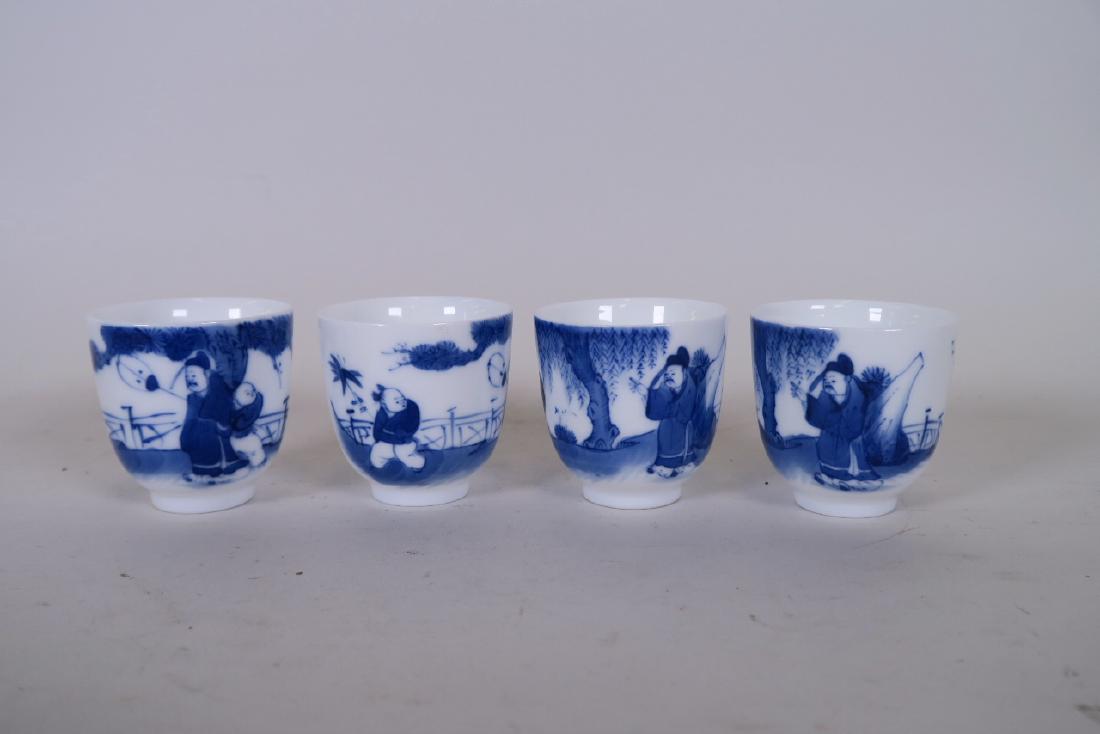 A set of four Chinese blue and white porcelain tea: A set of four Chinese blue and white porcelain tea bowls decorated with a sage and boys, 4 character mark to base, 2" high