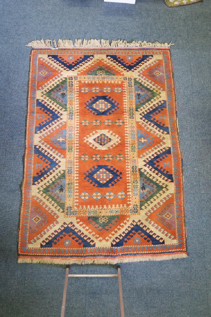 A Persian hand woven wool carpet with geometric designs (1 of 3)