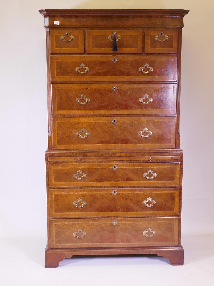 A 'British Antique Replicas' Georgian style burr walnut: A 'British Antique Replicas' Georgian style burr walnut chest on chest with the upper drawers over six graduated drawers, each crossbanded and herringbone inlaid, having brass drop handles, 43" x 23"
