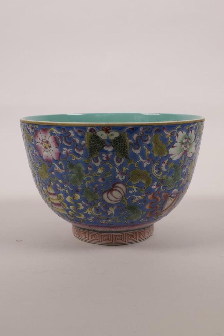 A Chinese polychrome enamelled porcelain rice bowl with: A Chinese polychrome enamelled porcelain rice bowl with steep sides, decorated with flowers and the Eight Buddhist Treasures, 4 character mark to base, 5½" diameter