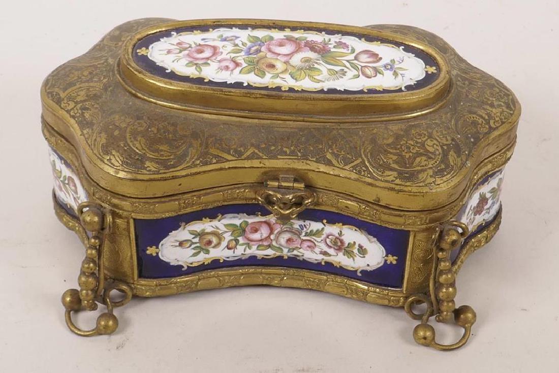 A Continental enamel trinket box with ormolu mounts,: A Continental enamel trinket box with ormolu mounts, painted with floral displays, A/F, 6½" long, 3" high