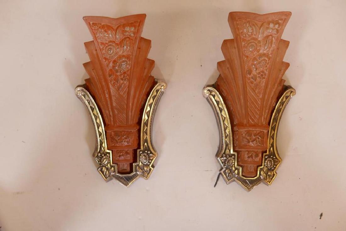 A pair of Art Deco wall lights, with chrome mounting: A pair of Art Deco wall lights, with chrome mounting plates and pressed glass shades, 12" high