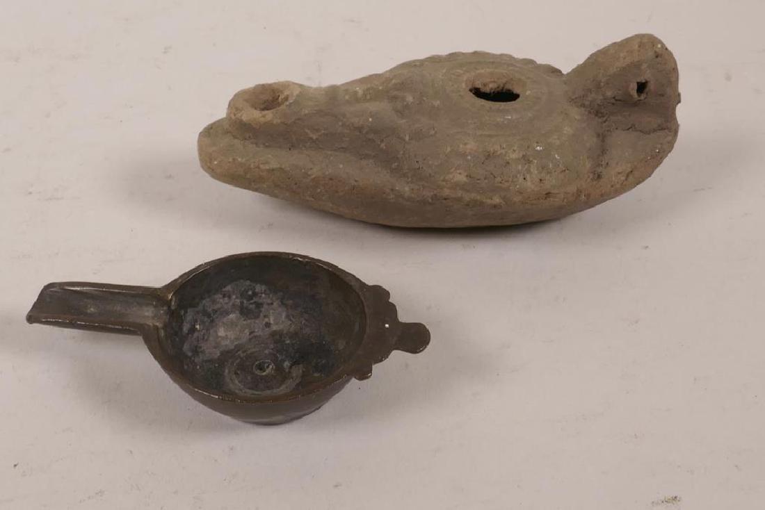 An earthenware Pre-Columbian oil lamp, 4½" long, and a: An earthenware Pre-Columbian oil lamp, 4½" long, and a small bronze bowl, 3" long