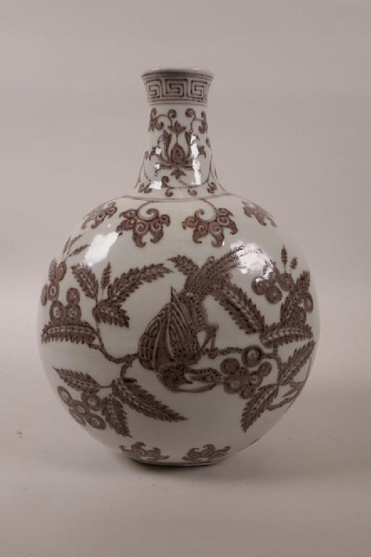 A Chinese red and white pottery moon flask decorated: A Chinese red and white pottery moon flask decorated with birds on fruiting branches, 11½" high