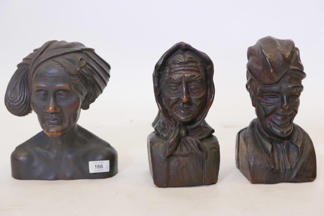 A late C19th/early C20th Balinese carved wood bust of a: A late C19th/early C20th Balinese carved wood bust of a woman, and a similar pair, possibly Dutch East Indies