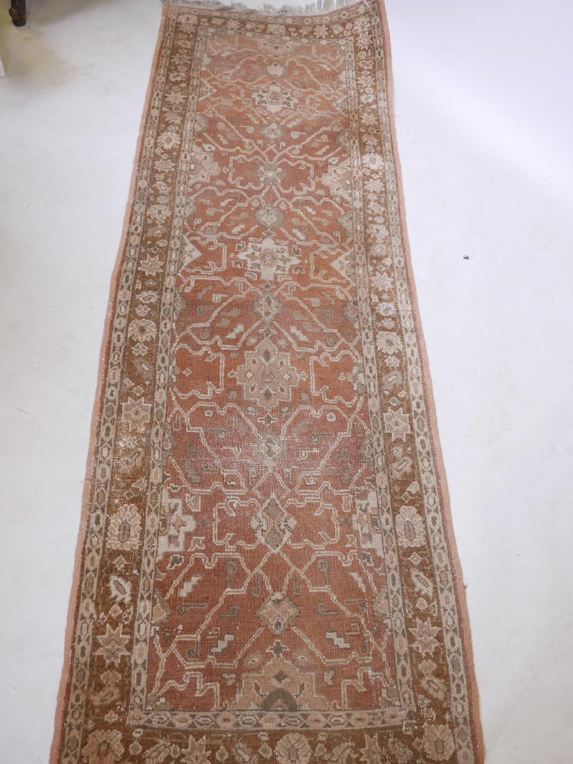 An Eastern wool runner, with geometric designs on a: An Eastern wool runner, with geometric designs on a terracotta field, 31" x 93"