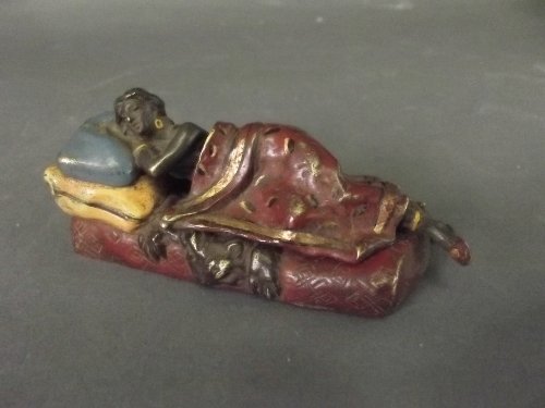 A cold painted bronze figure of a sleeping maiden with: A cold painted bronze figure of a sleeping maiden with removable blanket, 4'' long