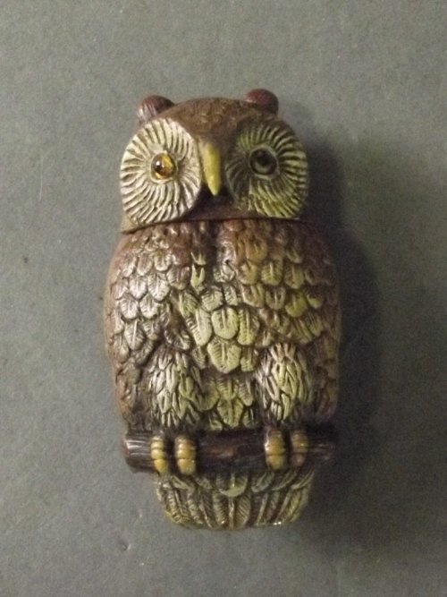 A cold painted brass vesta in the form of an owl with: A cold painted brass vesta in the form of an owl with glass eyes, 2¼'' long